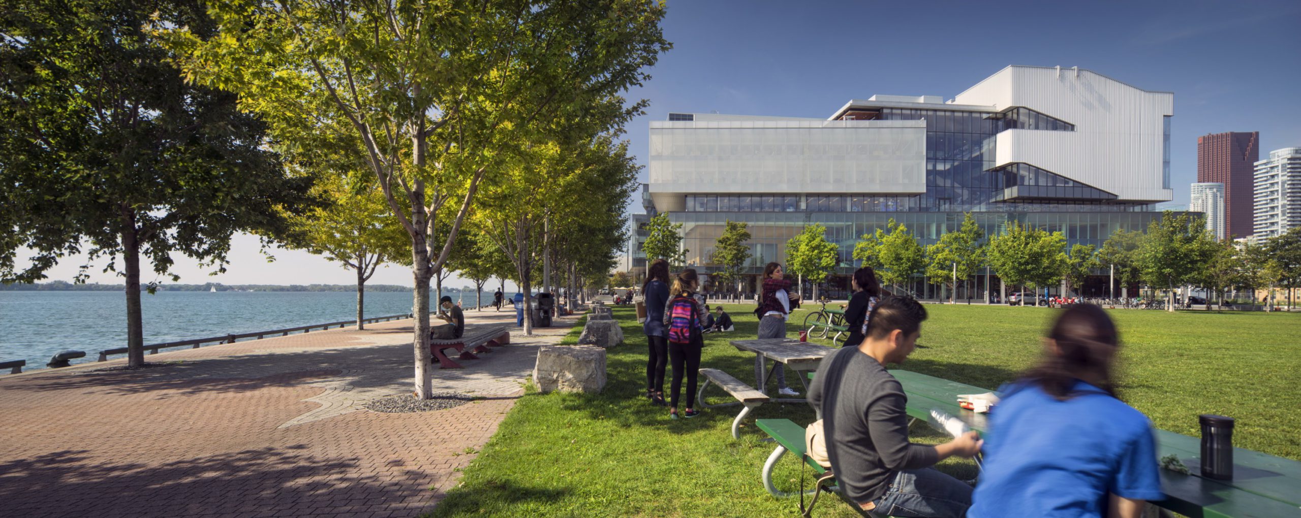 George Brown College, Daphne Cockwell Centre for Health Sciences - Exterior during day with people eating at tables